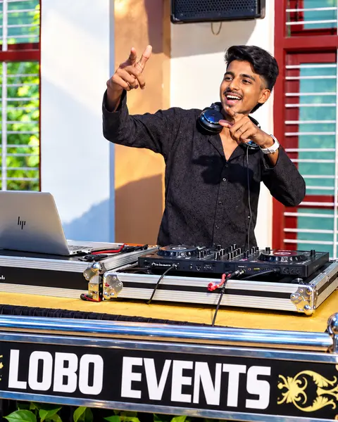 DJ Rev at a Lobo Events branded DJ booth with laptop and controller
