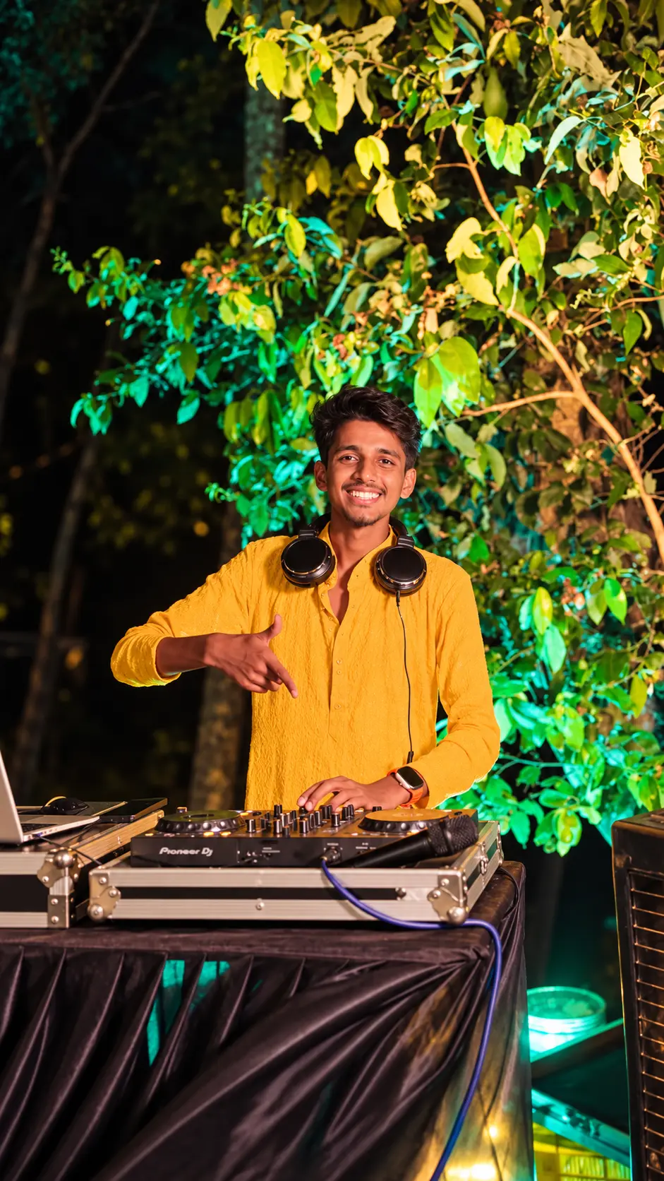 DJ Rev in a yellow kurta at a garden night party